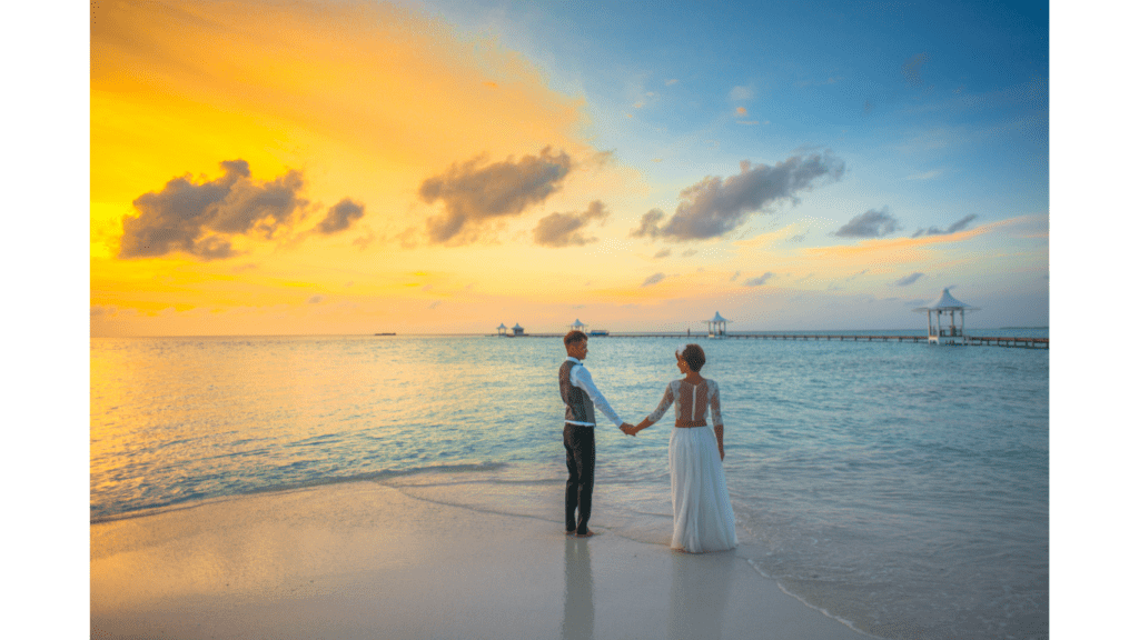 couple in a beach|white sand resort