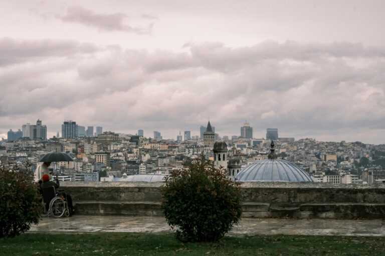 A scenic rainy view from a rooftop in Istanbul, overlooking the city and iconic Galata Tower.